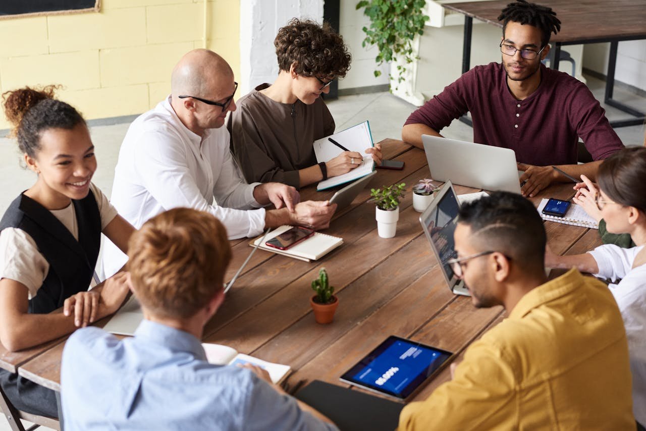 A group of professionals having a meeting in a modern office environment, fostering teamwork and brainstorming.